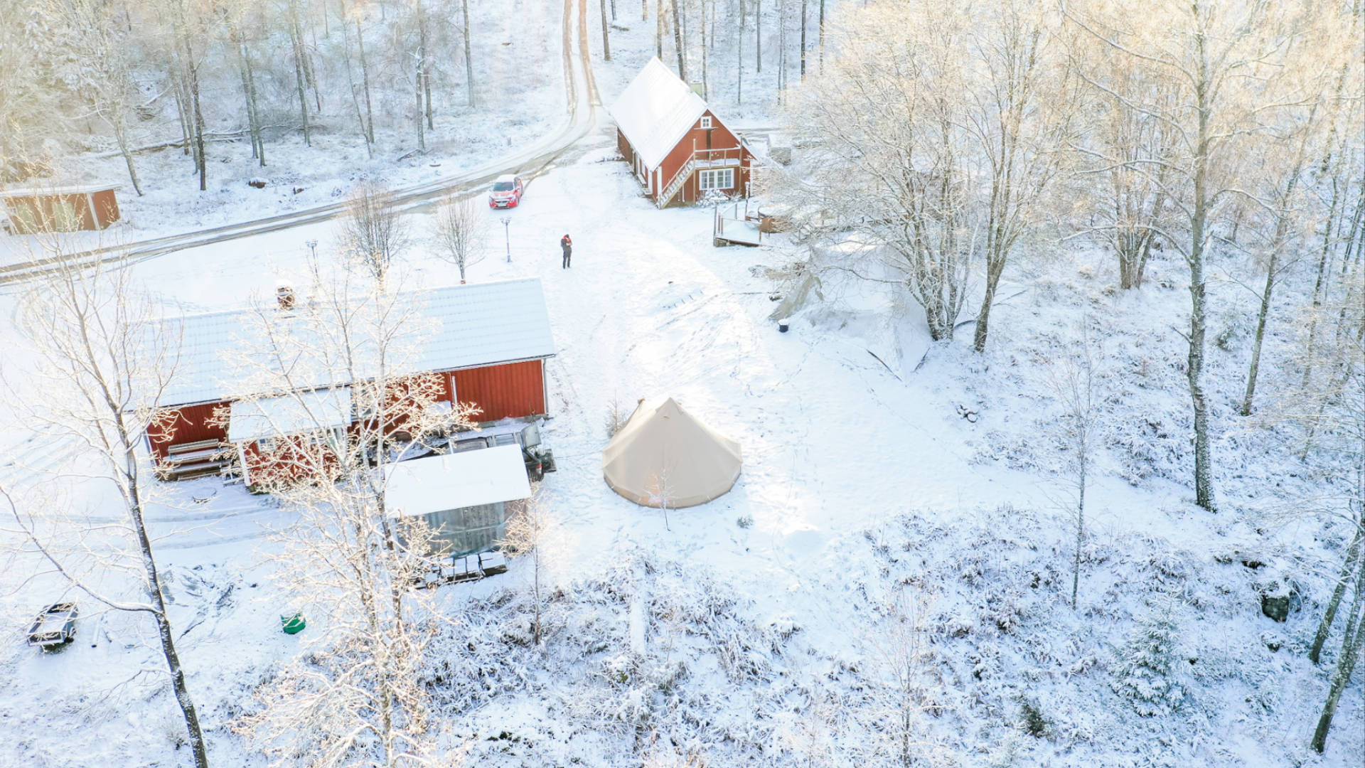Glamping tent in a forest with snow on the ground